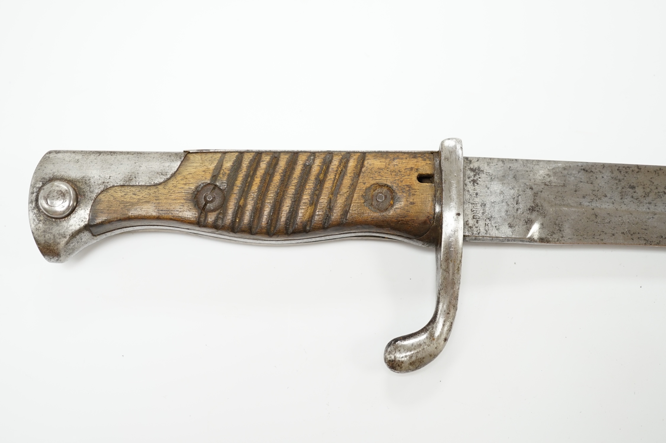 A WWI German Mauser bayonet with wooden grips. Condition - fair, some wear